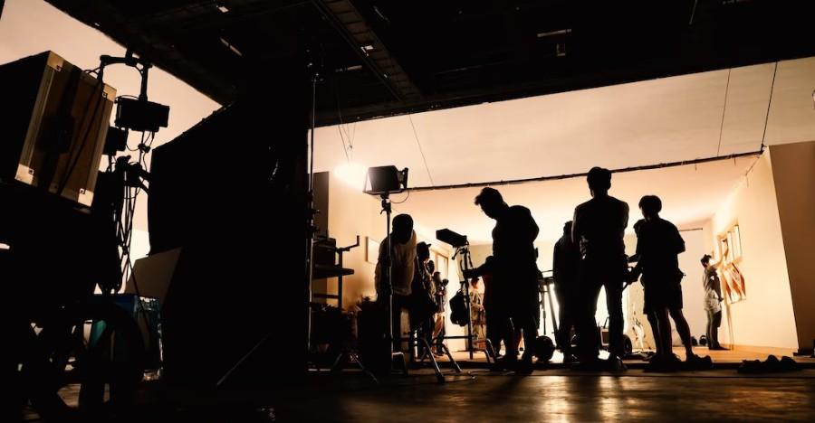Crew silhouetted on a lit studio set